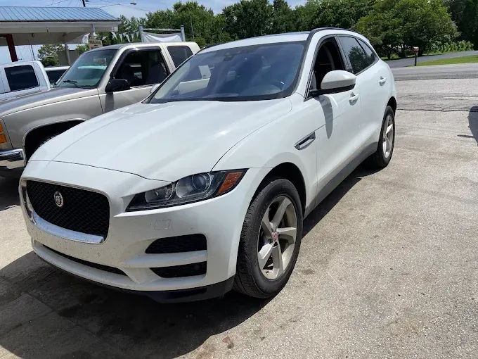 White Jaguar F-Pace parked at the shop
