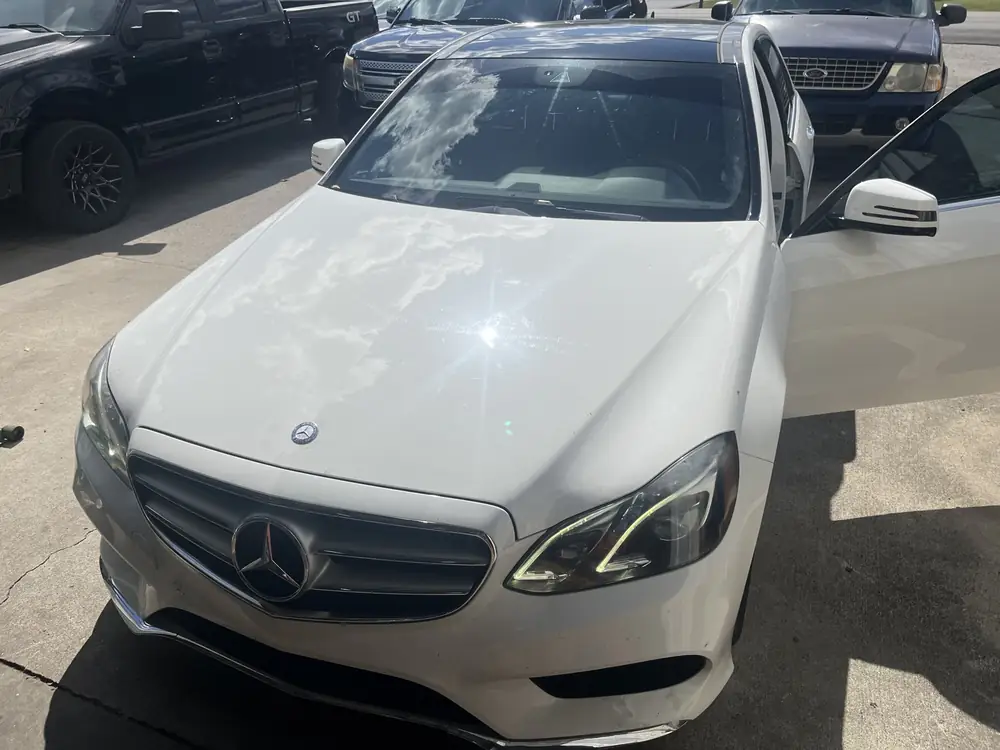 White Mercedes-Benz E-Class sedan parked at the shop