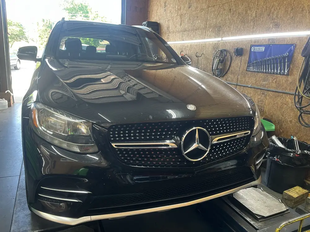 Front of a black Mercedes-Benz GLC in the service bay