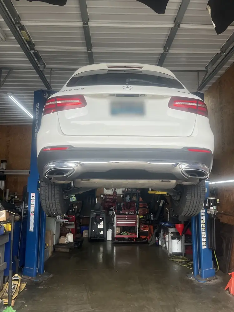White Mercedes-Benz GLC raised on the lift