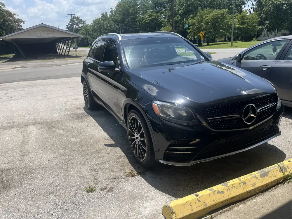 Black Mercedes-Benz GLC parked outside the shop