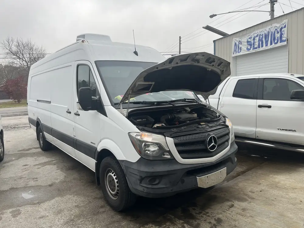 White Mercedes-Benz Sprinter van with the hood open