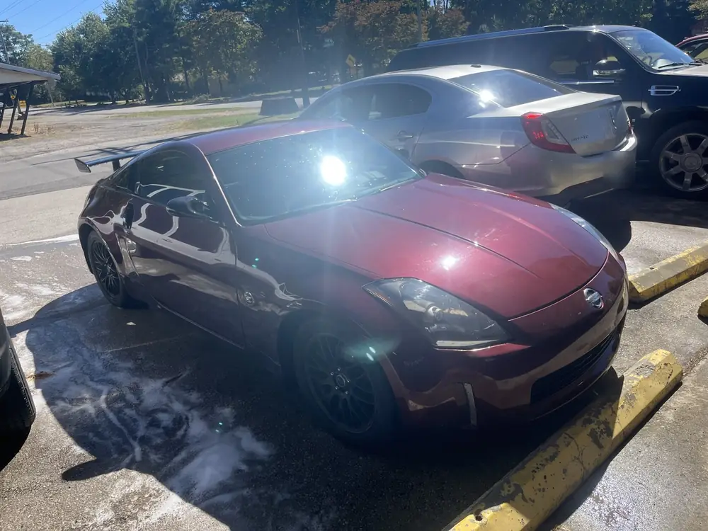 Burgundy Nissan 350Z parked at the shop